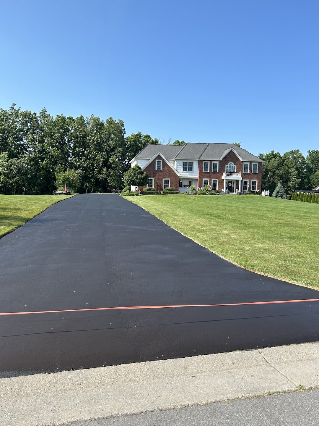 Glossy sealed driveway with sharp clean edges