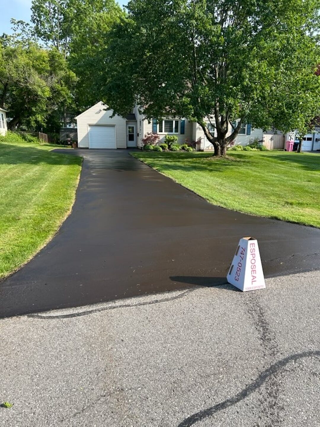 Freshly sealed driveway with bright black finish